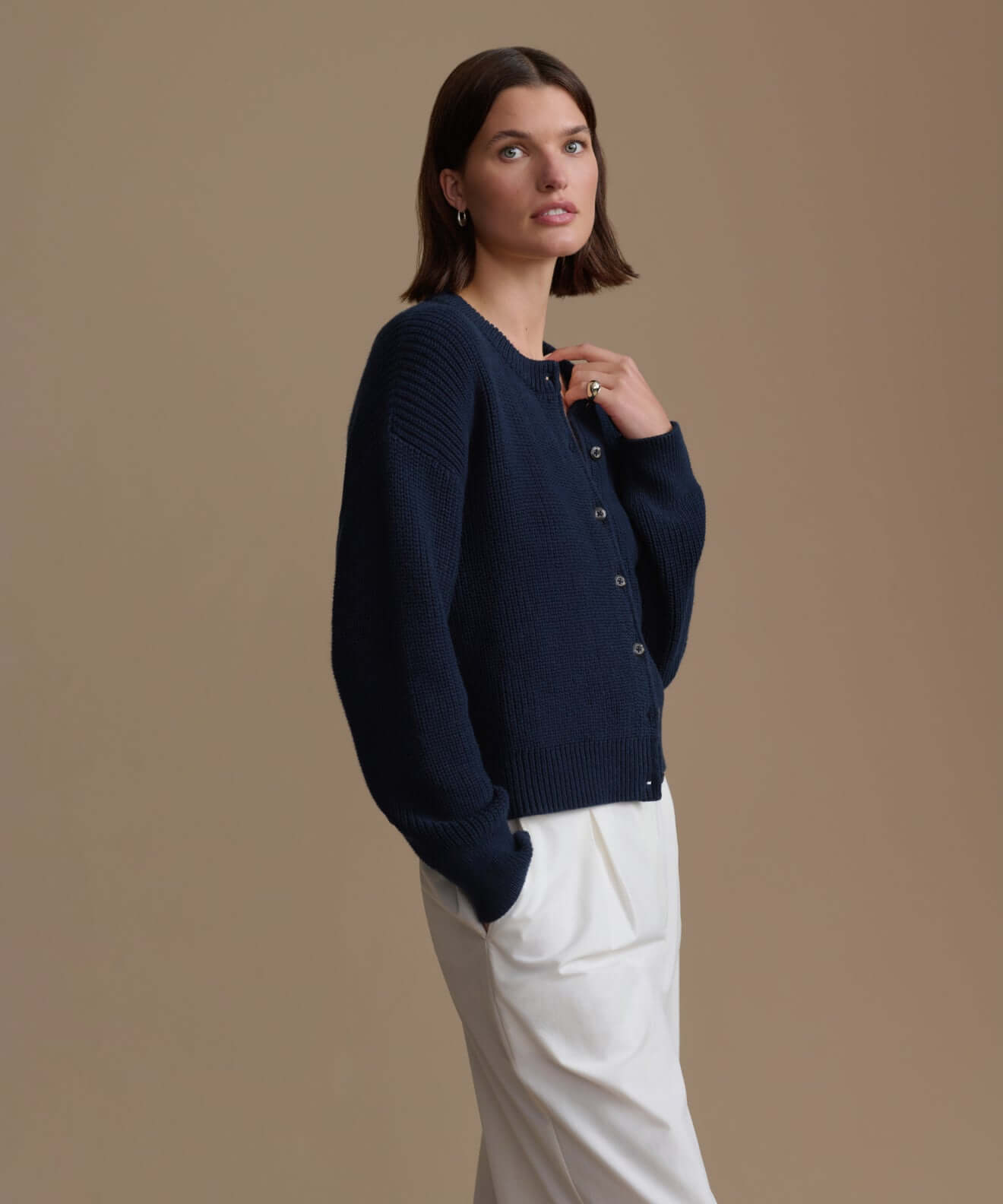 Model wearing a stylish navy blue sweater, showcasing the cozy design of our Sweaters collection.